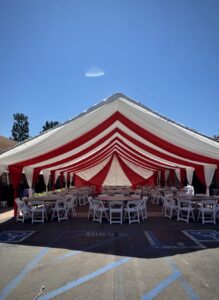 Alhambra event rentals featuring a 30x40 red and white draped canopy setup by Krystal’s Party Rentals