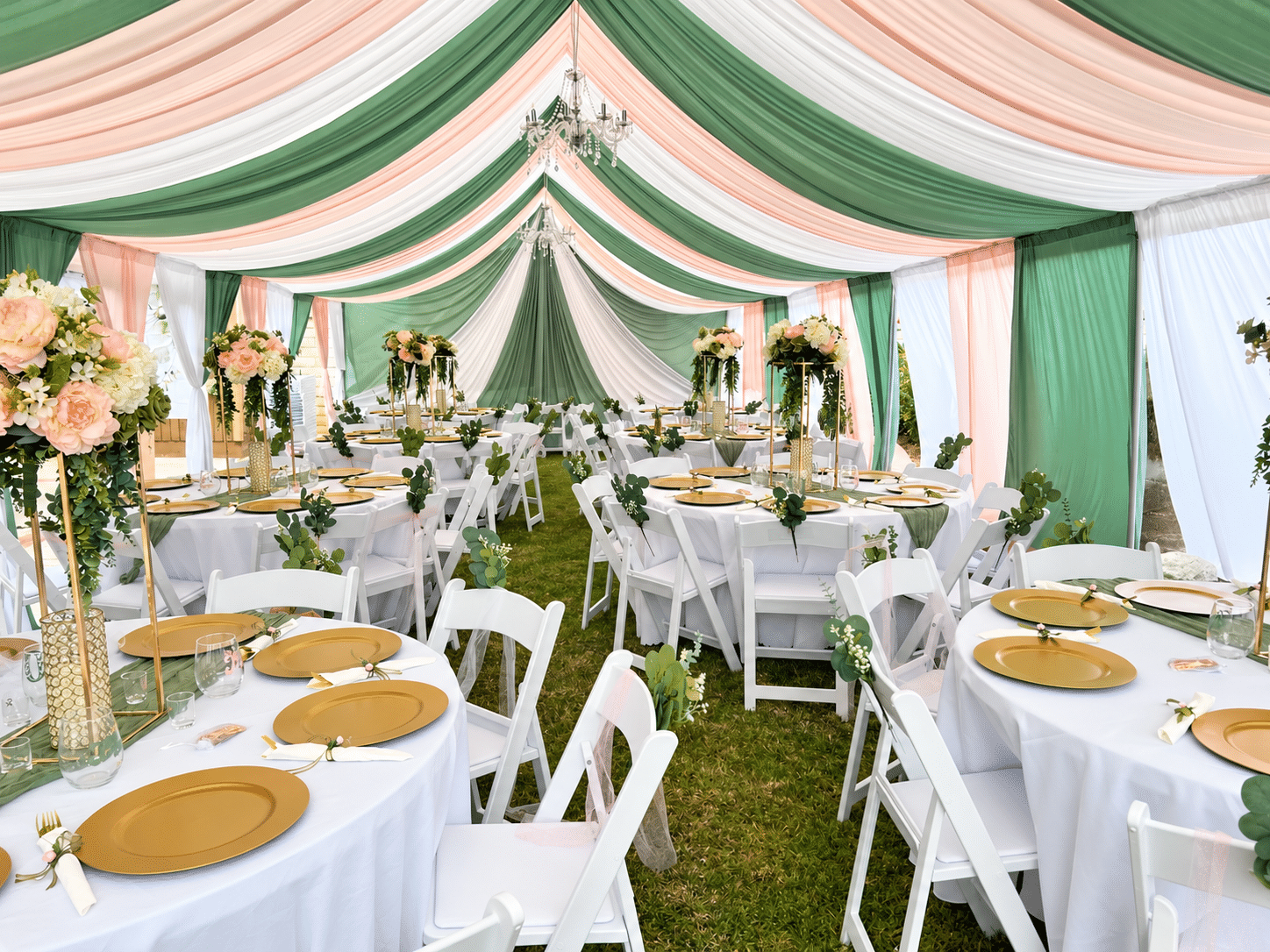 Sage green, blush pink and ivory draped canopy with chandeliers and elegantly arranged event tables