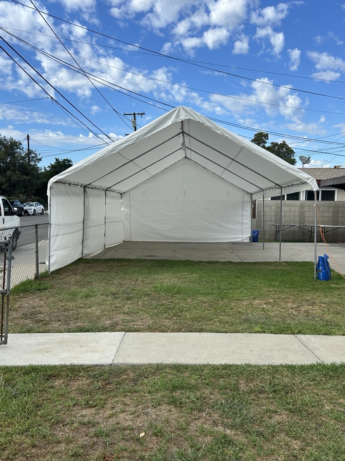 Open white A-frame regular canopy in a residential yard
