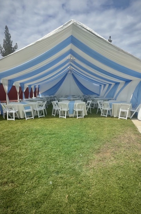 Furnished 30 by 40 A-frame canopy with blue and ivory draping and round tables