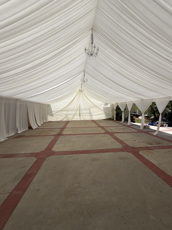 Ivory draped A-frame canopy with chandeliers